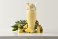 Pineapple milkshake with cream decorated with fruit on table isolated Royalty Free Stock Photo