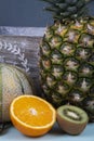 Pineapple, orange half, chopped kiwis and honeydew melon. Royalty Free Stock Photo