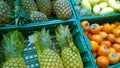 Pineapple and persimmon in boxes on supermarket shelves. Fresh fruits at Farmers market stall. Retail industry. Discount. Grocery Royalty Free Stock Photo