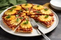 pineapple pizza slices arranged radially on a white plate with a silver fork Royalty Free Stock Photo