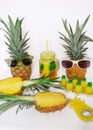 Pineapple set Two pineapples in sunglasses, a mug with juice, one pineapple, a can opener and candles in the shape of pineapples Royalty Free Stock Photo