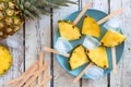 Pineapple slice popsicles, top view over white wood Royalty Free Stock Photo