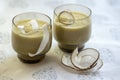 Pineapple smoothie with bananas, oatmeals and coconut milk, decorated with coconut chips, Christmas breakfast, white tablecloth Royalty Free Stock Photo