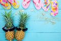 Pineapple with summer accessory on blue wooden background Royalty Free Stock Photo