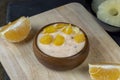 pineapple yogurt with slices of ripe yellow orange