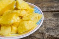 Close up Pineapple succulent delicious aroma, cut into pieces in the dish on the table as the background. Royalty Free Stock Photo