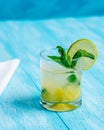 Pineapple mojito cocktail on a bright blue background