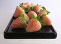 Pineberries on a black plate Royalty Free Stock Photo