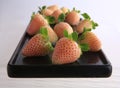 Pineberries on a black plate