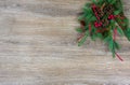 Pinecones, red berries, and a red ribbon on a spruce bough with