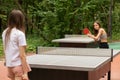 Ping pong outdoor, teenager girls playing table tennis with table tennis rackets and ping pong ball Royalty Free Stock Photo