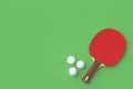 Ping pong paddle with balls on green background. Game for leisure. Sport equipment Royalty Free Stock Photo