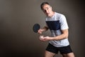 Ping-pong player ready to make a serve on gray background Royalty Free Stock Photo