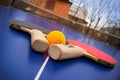 Ping-pong rackets and a ball on the table