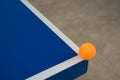 Pingpong ball hits the corner of blue pingpong table Royalty Free Stock Photo