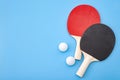 Pingpong lesson and winning competitive challenge concept with red and black table tennis or ping pong paddle isolated on blue Royalty Free Stock Photo