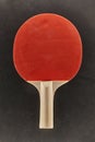 Pingpong racket on dark surface