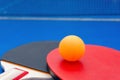 Pingpong rackets and ball and net on blue pingpong table Royalty Free Stock Photo