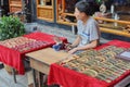 Young Chinese man making wooden combs Royalty Free Stock Photo