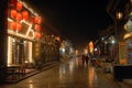 Pingyao in Shanxi Province, China: Street scene in Pingyao at night with city lights and red lanterns Royalty Free Stock Photo