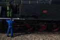 Pinhao, portugal - july 15, 2017:a mechanich fixes an ancient steam train