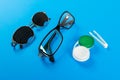 Pinhole glasses, lenses with container and glasses for sight. Medical concept. A set of accessories for sight. Top view Royalty Free Stock Photo