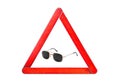 Pinhole glasses among warning triangle on a light background