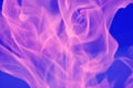 Abstract glare of flames of pink light on a blue background. Royalty Free Stock Photo