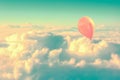Pink air balloon flying high in the sky above the clouds Royalty Free Stock Photo