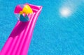 Pink air bed and beachball on swimming pool Royalty Free Stock Photo