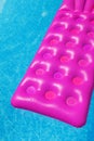 Pink air mattress in swimming pool. Holiday background. Royalty Free Stock Photo