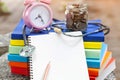 Pink alarm clock closeup standing on pile of books. Business Royalty Free Stock Photo