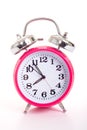 A pink alarm clock on a white background Royalty Free Stock Photo