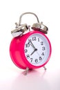 A pink alarm clock on a white background Royalty Free Stock Photo