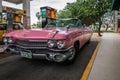 Pink american vintage car on the gas station in Havana Cuba