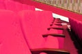 pink armchairs. Empty concert hall, theater chairs background ... color photo, empty cinema or concert hall. The red Royalty Free Stock Photo