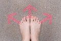 Pink Arrow Choice Concept. Female Bare Feet with Pink Nail Polish Manicure Standing and Many Direction Arrows Choices on the Road