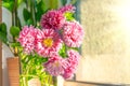 Pink asters in a vase on the table at home