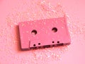 Pink audio cassette tape in glitters. Party concept minimal photo in 90s style