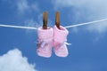 Pink baby booties haning on a clothes line Royalty Free Stock Photo
