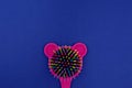 Pink baby comb of rainbow colors on a dark blue background