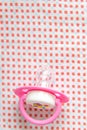 Pink baby dummy on swaddling clothes with red dot pattern Royalty Free Stock Photo