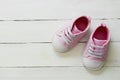 Pink baby girl shoes, on gray background. Newborn, motherhood, pregnancy concept with copy space Royalty Free Stock Photo