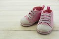 Pink baby girl shoes, on gray background. Newborn, motherhood, pregnancy concept with copy space Royalty Free Stock Photo