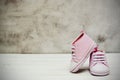 Pink baby girl sneakers, sport shoes close up on gray background. Newbord, motherhood, pregnancy concept with copy space Royalty Free Stock Photo