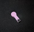 Pink baby nail clips on a black background