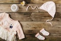 pink baby s dress with headwear pair socks milk bottle pacifier wooden table. High quality photo