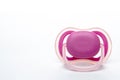 Pink baby`s orthodontic pacifier isolated on white background. Front View. Shows signs of use Royalty Free Stock Photo