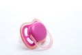 Pink baby`s pacifier isolated on white background. Side View. Shows signs of use Royalty Free Stock Photo