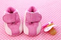 Pink baby shoes and dummy Royalty Free Stock Photo